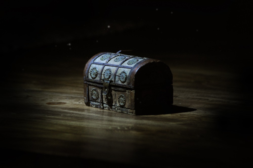 Group of friends solving puzzles inside a dimly lit, ancient temple-themed escape room at Mystic Escape Room